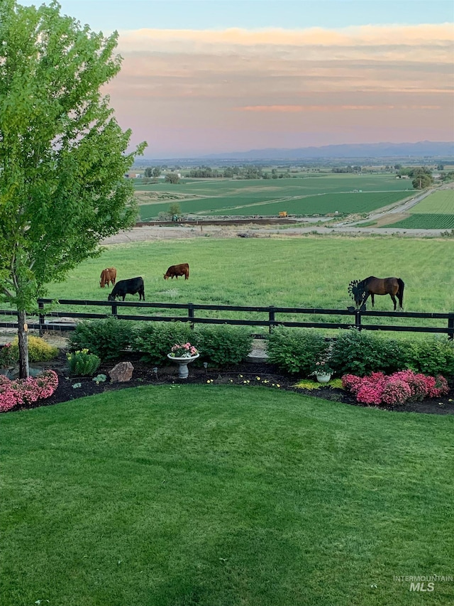 view of yard featuring a rural view and fence