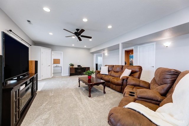 living room featuring ceiling fan and light colored carpet