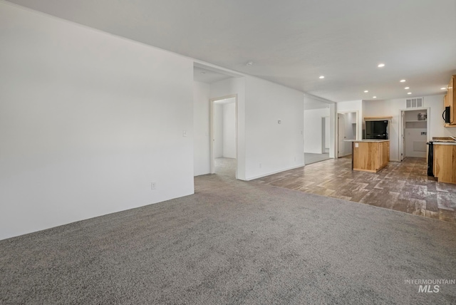 unfurnished living room with light colored carpet