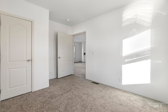 unfurnished bedroom with light colored carpet