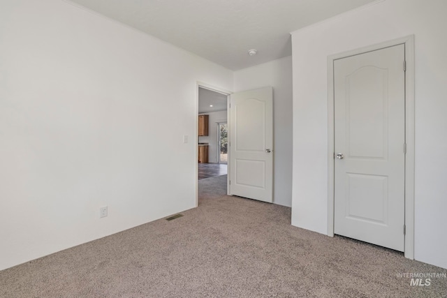 unfurnished bedroom featuring light colored carpet