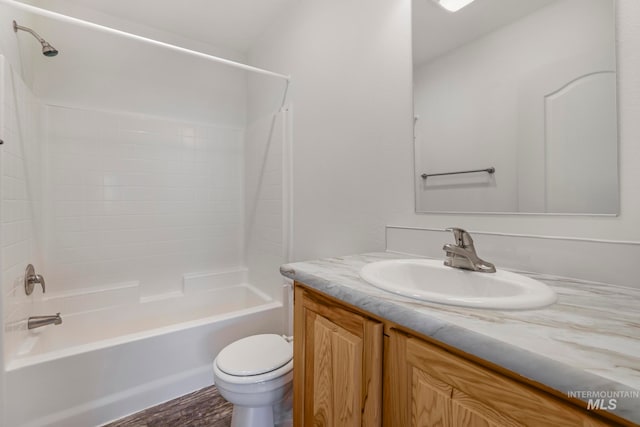 full bathroom with vanity, wood-type flooring,  shower combination, and toilet