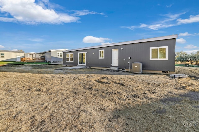 rear view of property with a deck and central AC