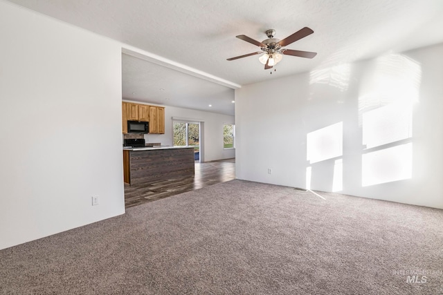 unfurnished living room with hardwood / wood-style flooring, ceiling fan, and a textured ceiling