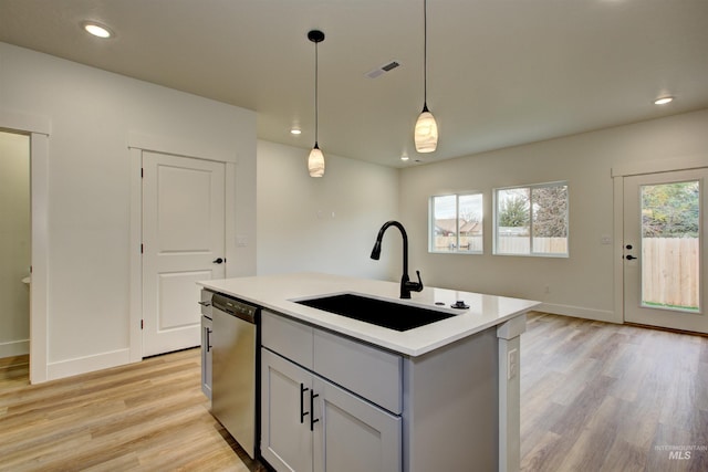 kitchen featuring dishwasher, plenty of natural light, visible vents, and a sink