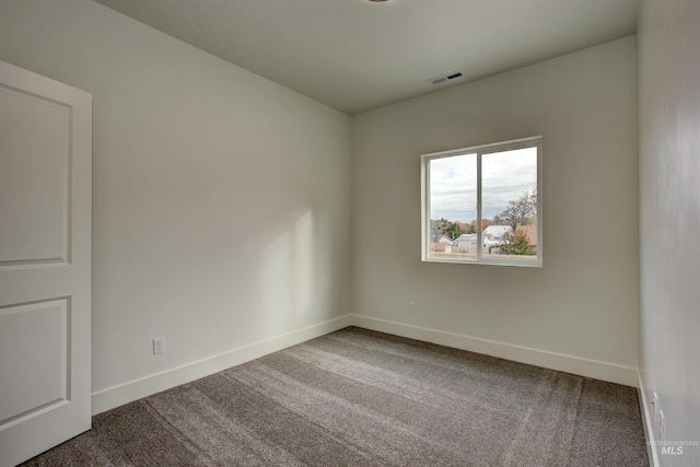 unfurnished room featuring visible vents, baseboards, and carpet