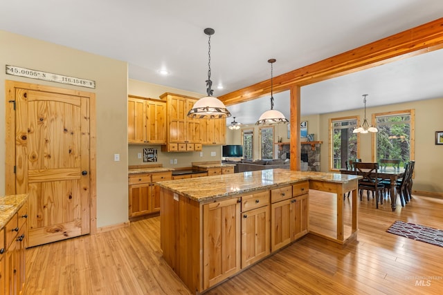 14199 Franklin Rd, Mccall, ID 83638 - kitchen with a chandelier, light wood-type flooring, light stone counters, hanging light fixtures, and beam ceiling