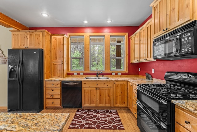 14199 Franklin Rd, Mccall, ID 83638 - kitchen with black appliances, light wood-style floors, light stone countertops, and recessed lighting