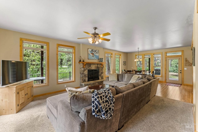 14199 Franklin Rd, Mccall, ID 83638 - living area with healthy amount of natural light, a stone fireplace, ceiling fan, and light wood-style floors