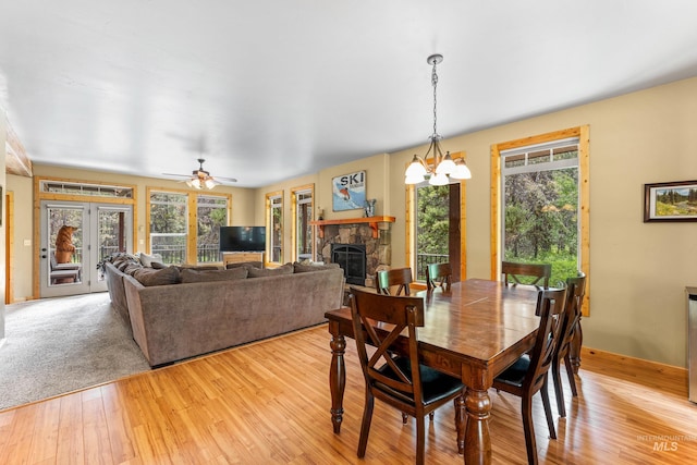 14199 Franklin Rd, Mccall, ID 83638 - dining room featuring plenty of natural light, light wood-style floors, and a stone fireplace