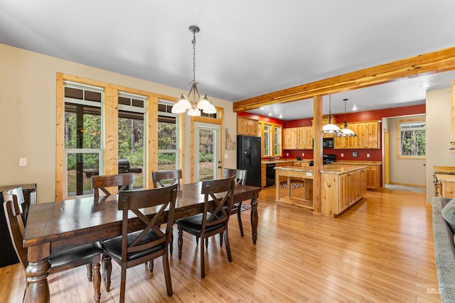 14199 Franklin Rd, Mccall, ID 83638 - dining area with a chandelier, light wood-style flooring, and beamed ceiling