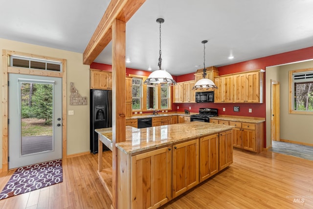 14199 Franklin Rd, Mccall, ID 83638 - kitchen with black appliances, healthy amount of natural light, light wood-style floors, a center island, and recessed lighting