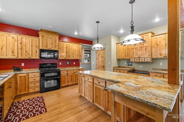 14199 Franklin Rd, Mccall, ID 83638 - kitchen with black appliances, light wood-style flooring, hanging light fixtures, recessed lighting, and a center island