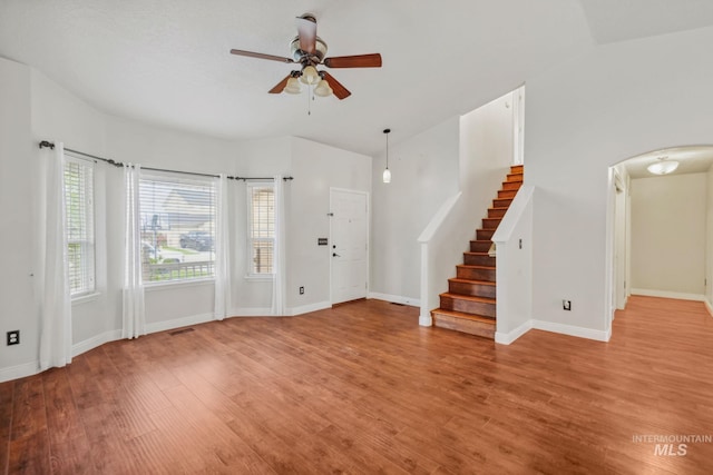 5101 Barkley Way, Caldwell, ID 83607 - foyer featuring a ceiling fan, arched walkways, light wood finished floors, stairway, and baseboards