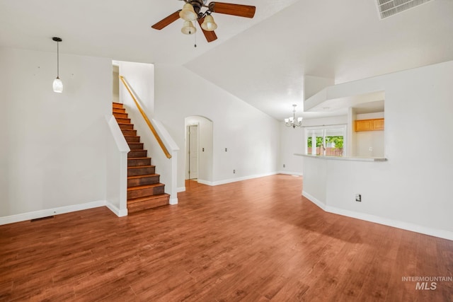 5101 Barkley Way, Caldwell, ID 83607 - unfurnished living room with a ceiling fan, a chandelier, light wood-style floors, vaulted ceiling, and stairway