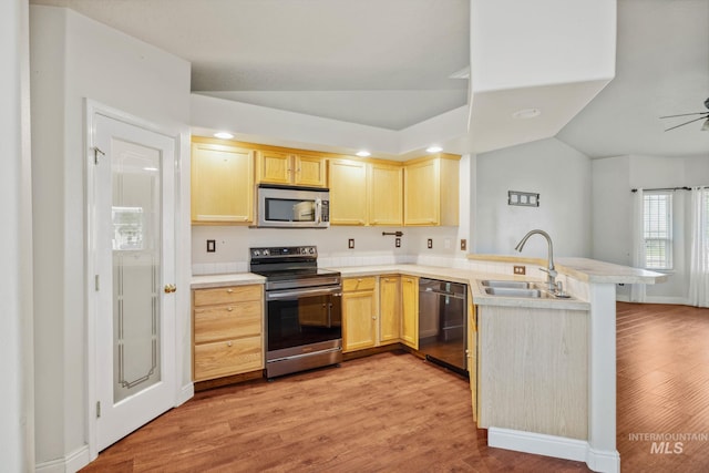 5101 Barkley Way, Caldwell, ID 83607 - kitchen with stainless steel appliances, a peninsula, a sink, light brown cabinets, and light wood-type flooring