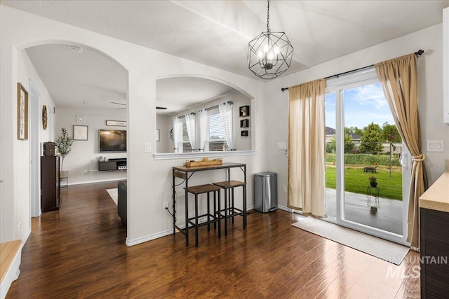 8096 E Jacob, Nampa, ID 83687 - kitchen with wood finished floors, arched walkways, pendant lighting, and light countertops
