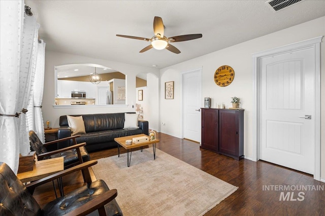 8096 E Jacob, Nampa, ID 83687 - living area featuring arched walkways, ceiling fan, and dark wood-style floors