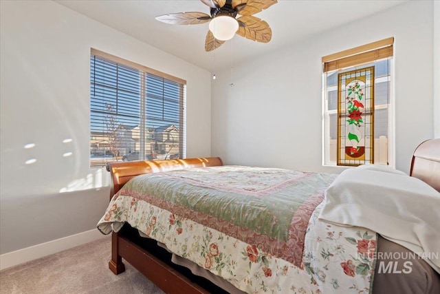 bedroom featuring a ceiling fan, carpet, and baseboards