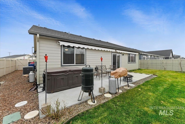 rear view of property with central air condition unit, a patio, a lawn, and a fenced backyard