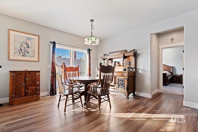 dining room featuring baseboards and wood finished floors