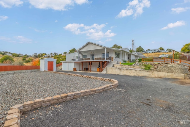 view of front of house featuring a storage shed