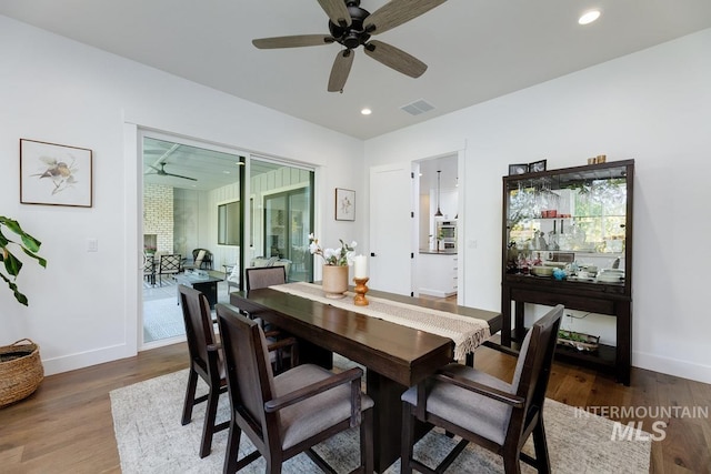 dining room featuring visible vents, wood finished floors, recessed lighting, baseboards, and ceiling fan