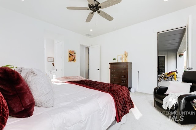 bedroom with light carpet, visible vents, and ceiling fan