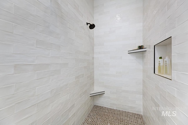 bathroom with a tile shower