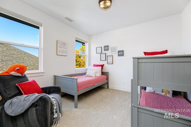 bedroom with visible vents, baseboards, and carpet