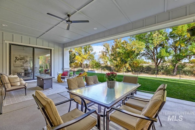 view of patio with outdoor dining area, a ceiling fan, and fence private yard