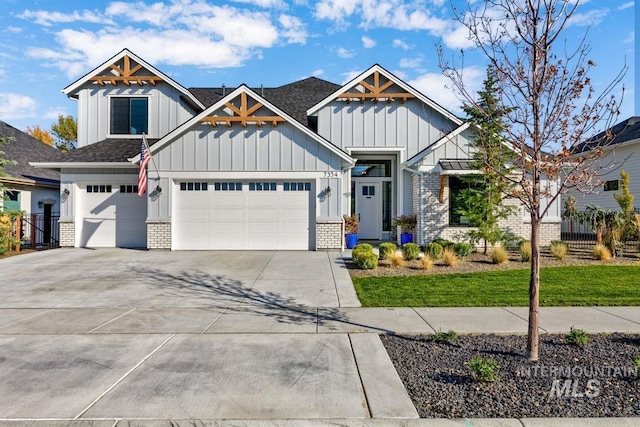 craftsman house with board and batten siding, fence, brick siding, and driveway