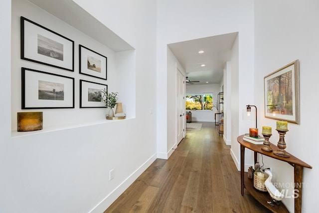 hallway with recessed lighting, wood finished floors, and baseboards