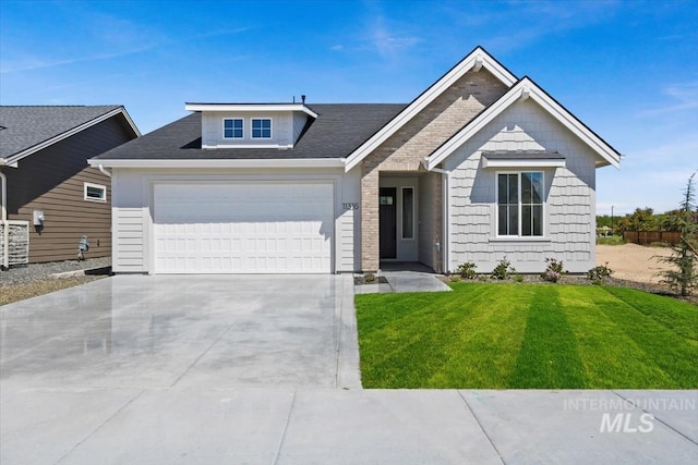 view of front of home with a garage and a front yard