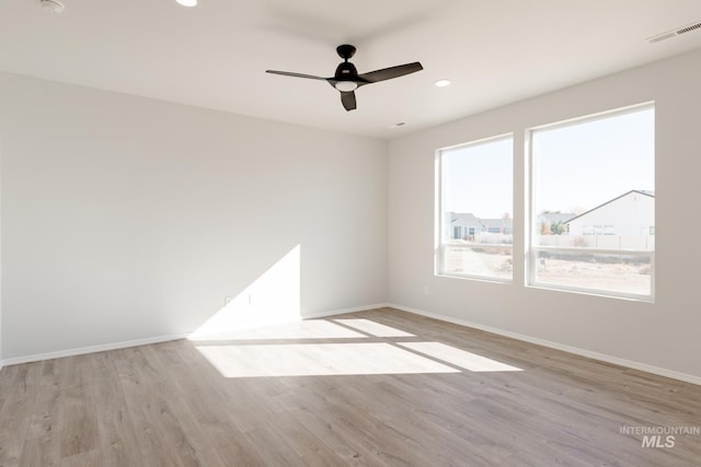 spare room featuring ceiling fan and light wood-type flooring