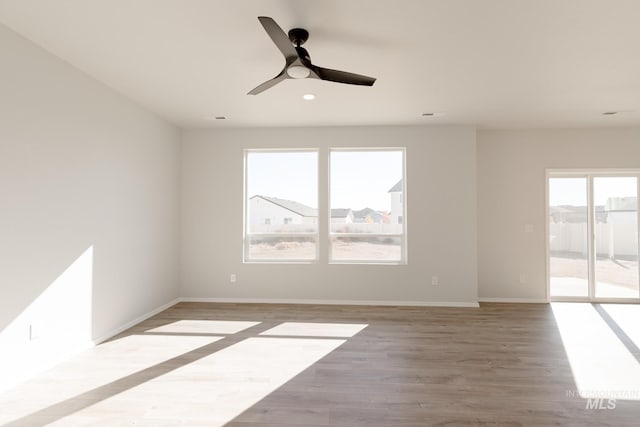 spare room with ceiling fan and light hardwood / wood-style flooring