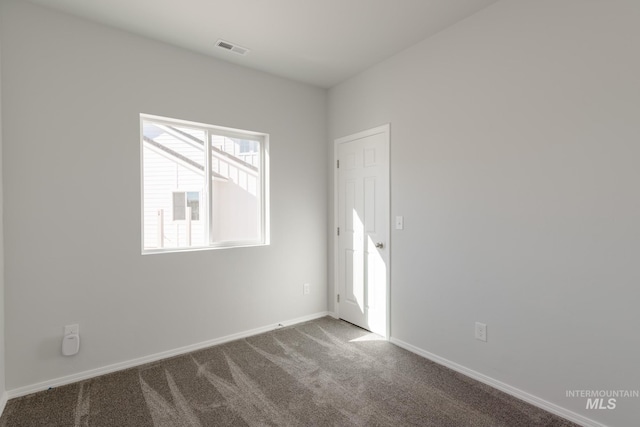 spare room featuring carpet