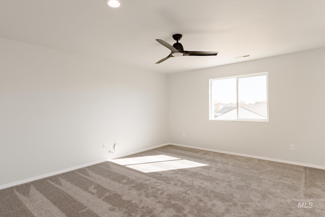 carpeted empty room featuring ceiling fan