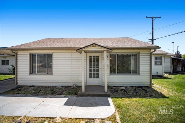 115 E Clark Ave, Nampa, ID 83686 - view of front of house featuring a front lawn and a shingled roof