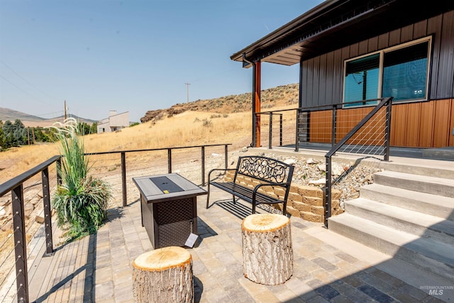 view of patio / terrace featuring a mountain view and a fire pit