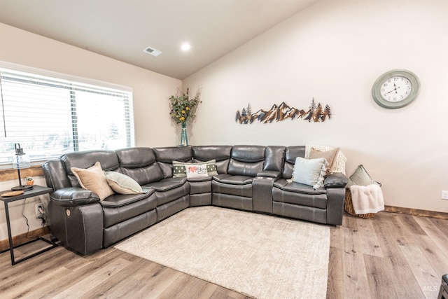 living room featuring light hardwood / wood-style floors and lofted ceiling