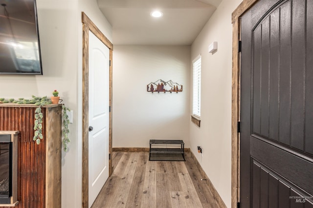 hallway with light hardwood / wood-style floors