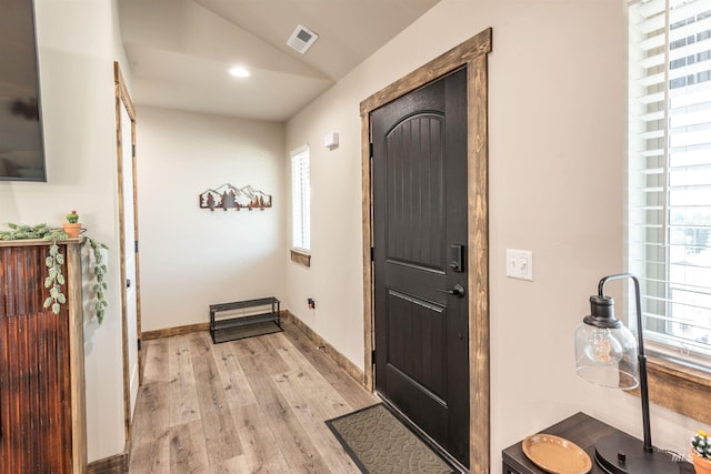 entrance foyer featuring light hardwood / wood-style floors and lofted ceiling