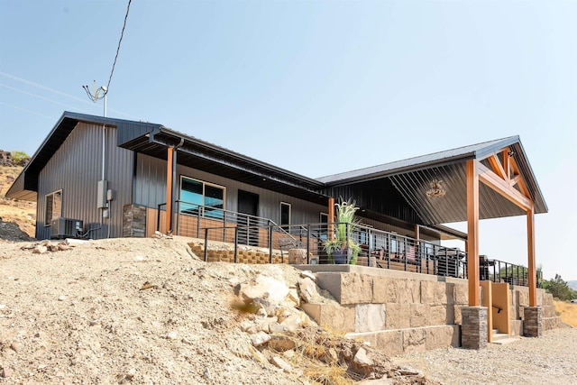 view of front of house with central AC unit and an outdoor structure