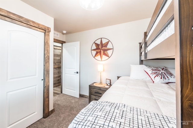 bedroom featuring dark carpet