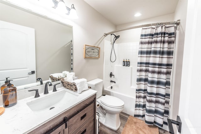 full bathroom featuring hardwood / wood-style floors, vanity, toilet, and shower / bath combo with shower curtain