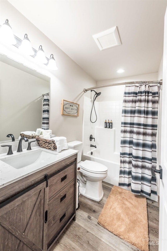 full bathroom featuring wood-type flooring, vanity, toilet, and shower / bath combo