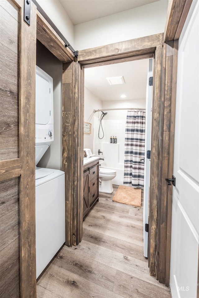 full bathroom with hardwood / wood-style floors, vanity, shower / tub combo with curtain, and toilet