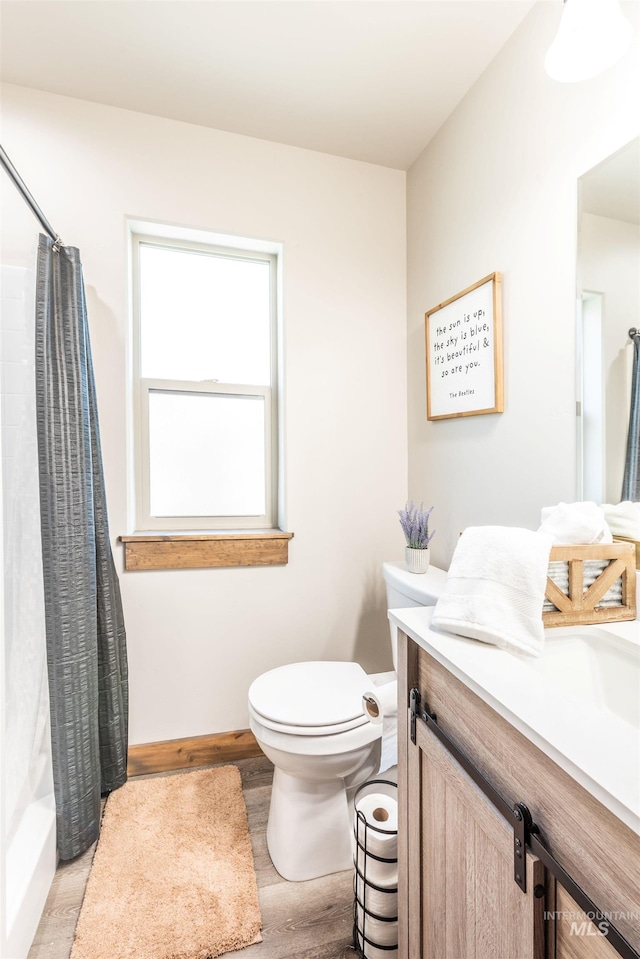 full bathroom with toilet, vanity, shower / tub combo, and hardwood / wood-style flooring