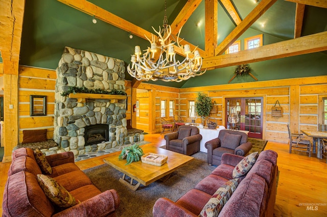 living room featuring a stone fireplace, beam ceiling, high vaulted ceiling, hardwood / wood-style floors, and a chandelier